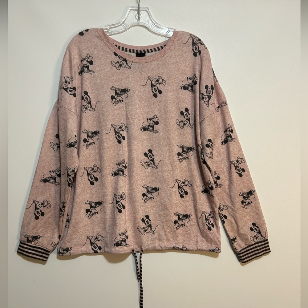 Pale pink, long-sleeved, Disney shirt with a Mickey Mouse design.